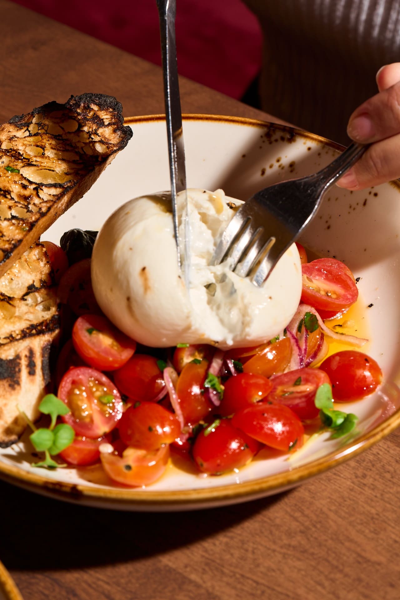 Italian sharing plates on a rustic table at Industria Pizzeria + Bar